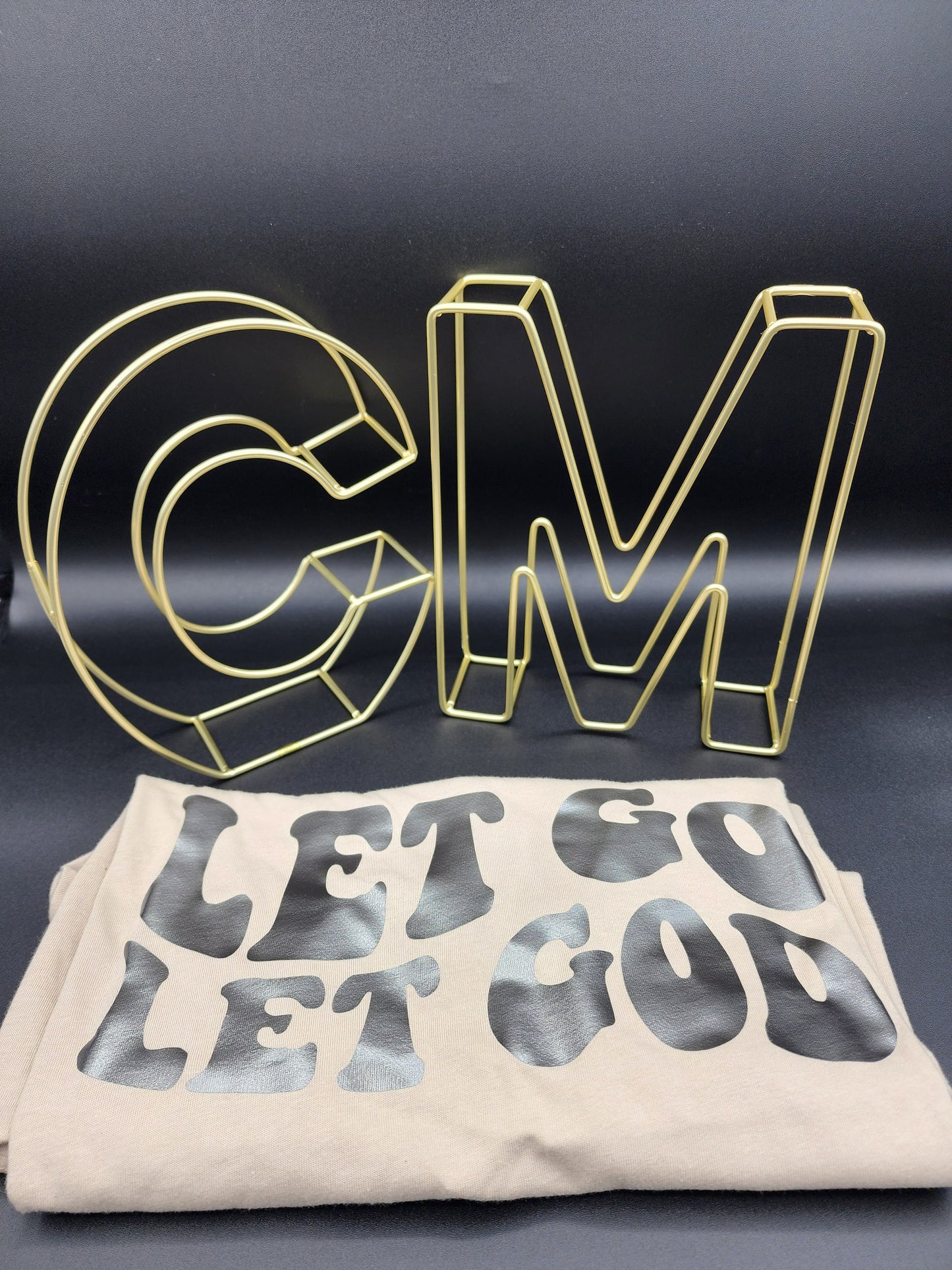Let go let God, tan color t-shirt.