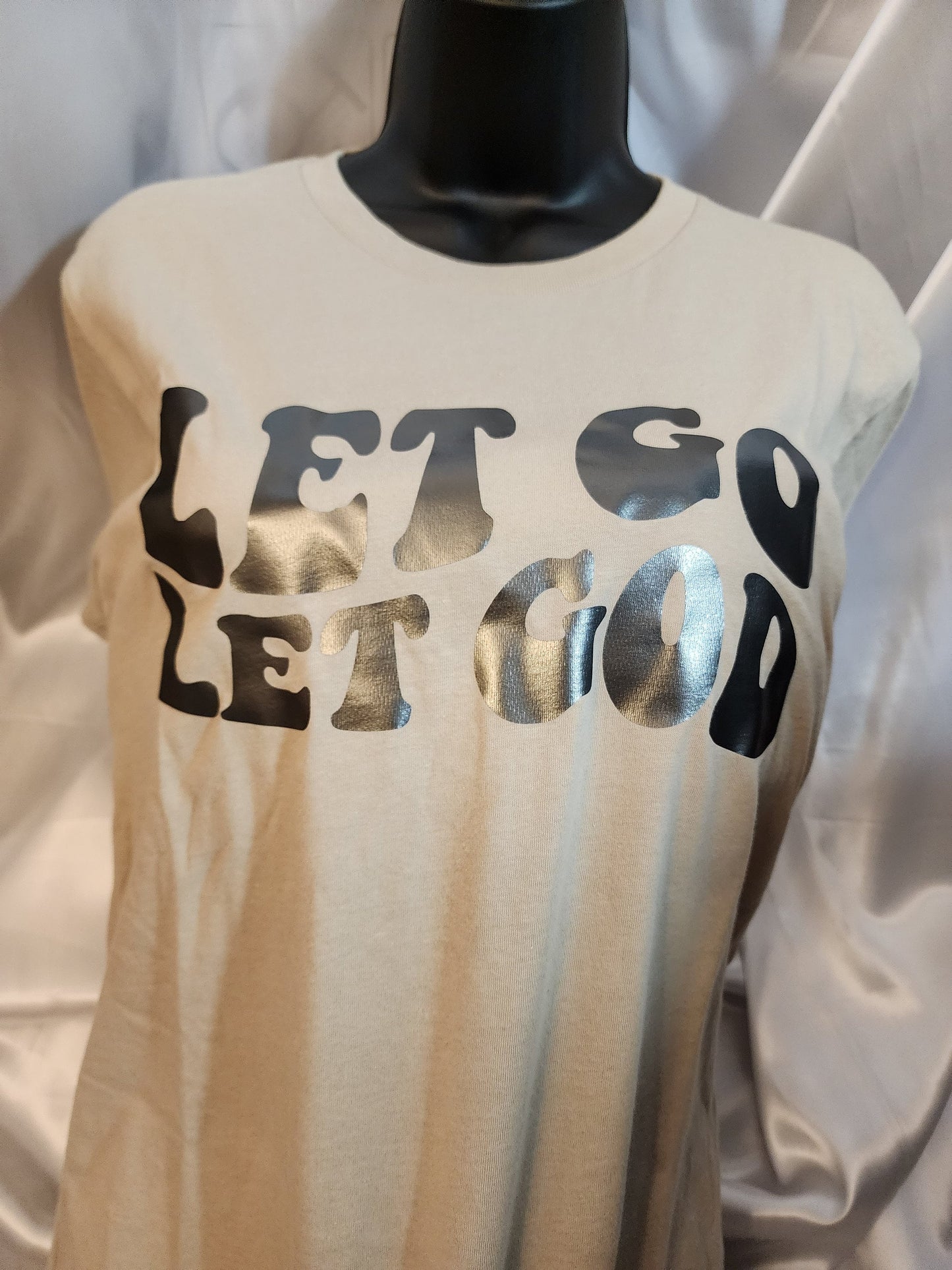 Let go let God, tan color t-shirt.